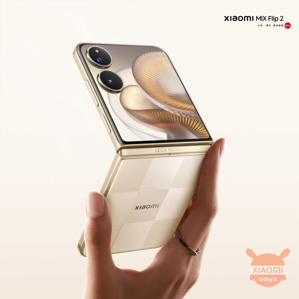 promotional poster of xiaomi mix flip 2, from behind, held by one hand